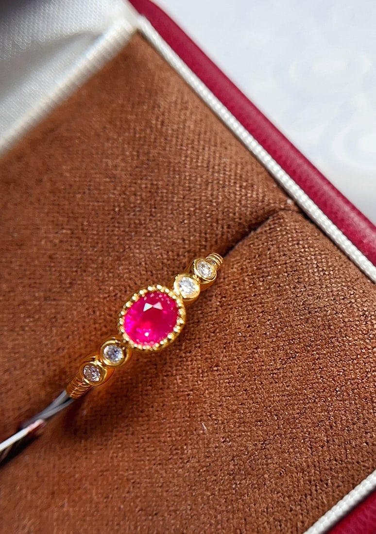 18K Gold Natural Unheated Ruby Ring: This ring is meticulously crafted in 18K gold, featuring an unheated pigeon blood red ruby with a glass-like clarity. The design is simple yet luxurious, perfect for collectors with a refined taste. (