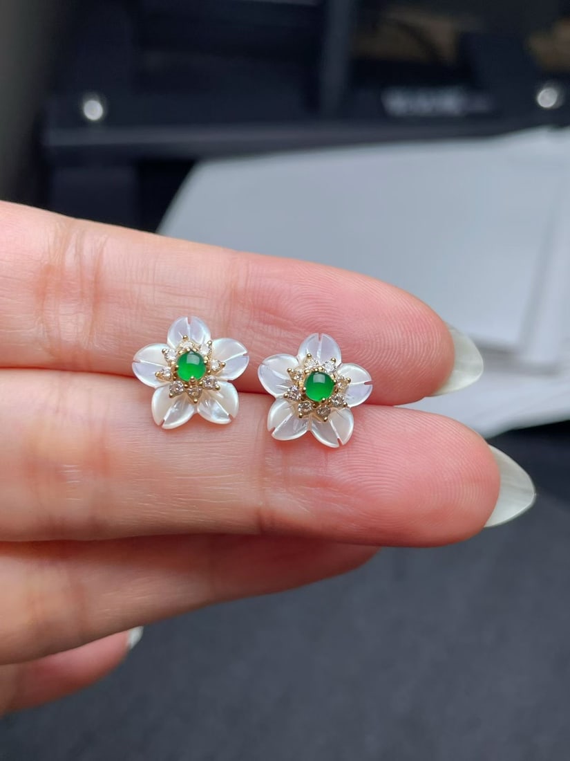 Silver Jade Earrings: These earrings feature a delicate jade flower design, exuding an elegant aura. The silver base complements the natural hue of the jade, suitable for various occasions.