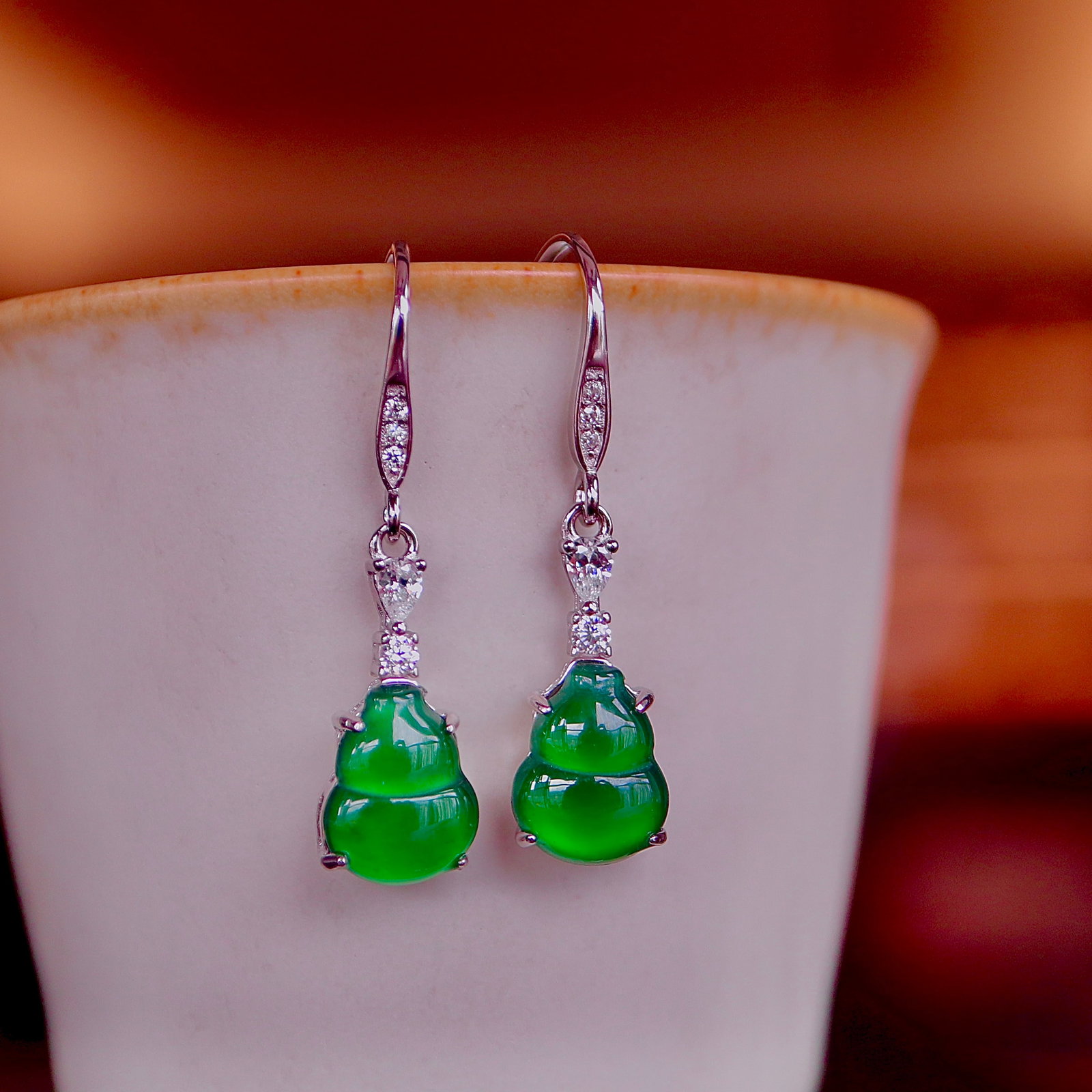 S925 Silver Natural Type A Jadeite Earrings: These earrings are crafted from natural Type A jadeite, with a gourd design symbolizing good fortune and prosperity. The high icy green hue showcases the natural allure of jadeite, set in S925 silver