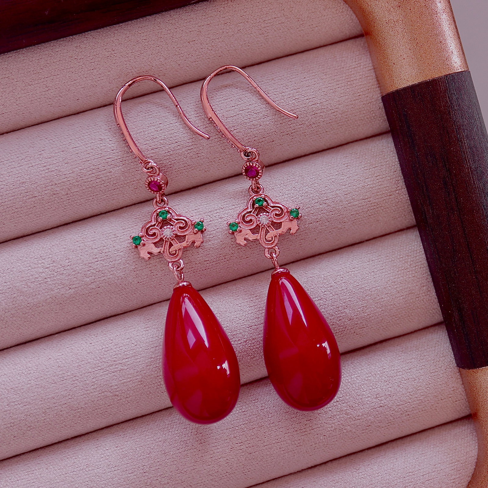 S925 Silver Natural Red Coral Earrings: These earrings feature natural red coral as the main stone, showcasing a delicate teardrop shape. Set in S925 silver with traditional gilding craftsmanship, they present a full and three-dimensional