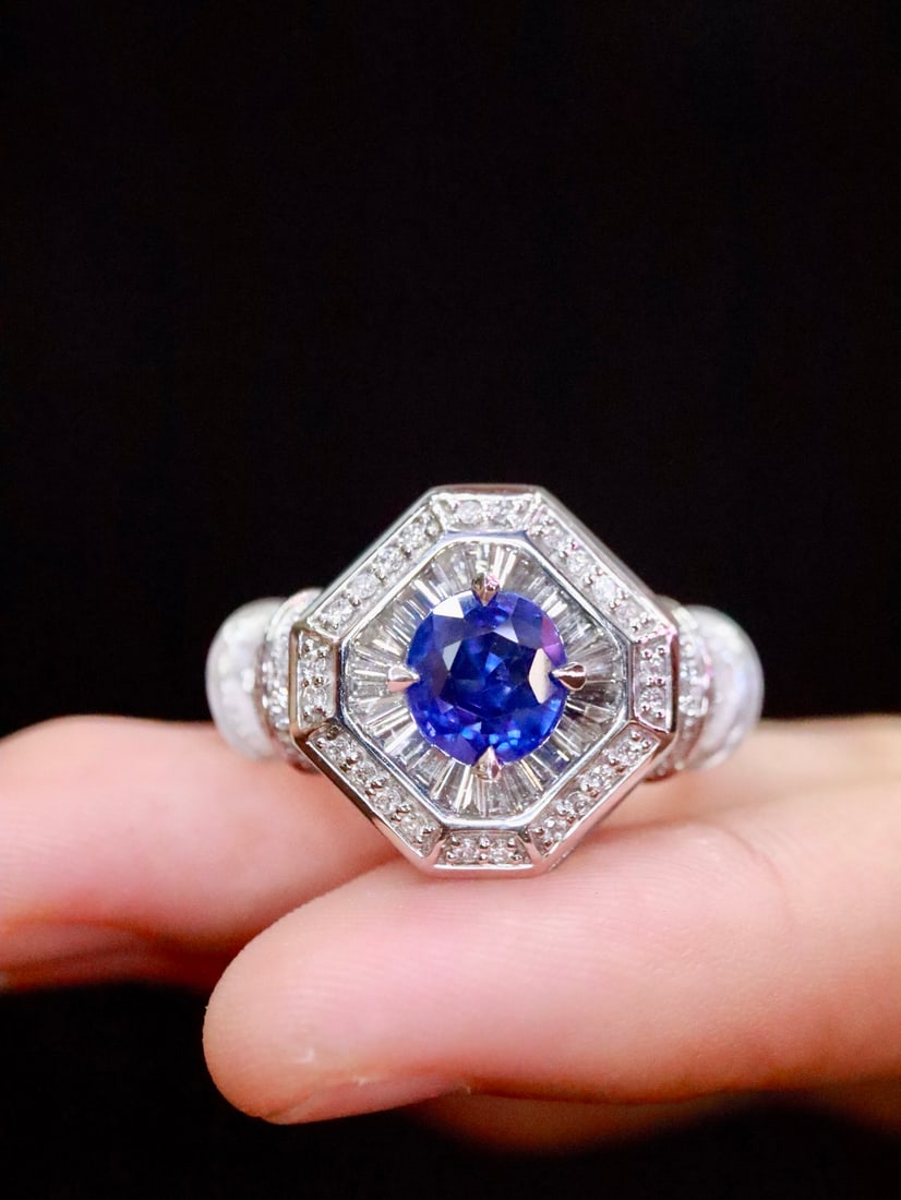 Platinum Natural Royal Blue Sapphire Ring: This ring features a geometrically shaped sapphire with a noble royal blue hue. The addition of white crystal highlights its unique texture, while the brilliant diamonds add a touch of luxury. Crafted