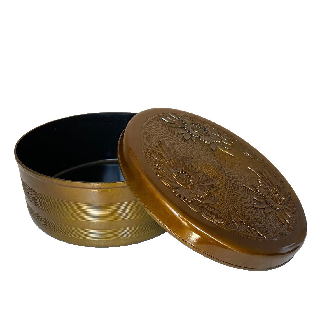 Gilt Lotus Carved Lacquer Inro: Gilded Lotus Carved Lacquer Inro This is a gilded lacquer inro, intricately carved with lotus motifs. The color is gold, and it is circular in shape, crafted from lacquer. It is of medium size. Due