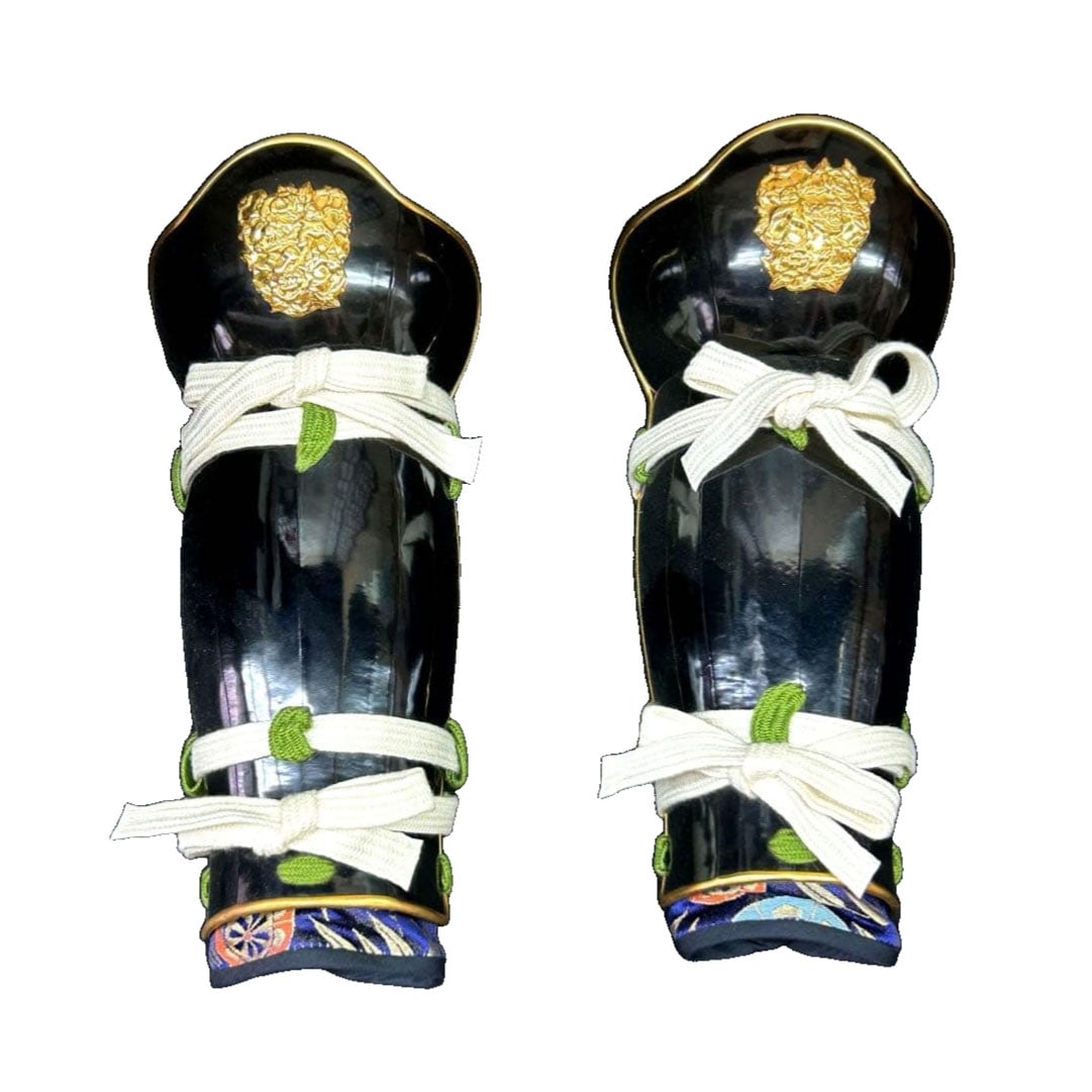 Lacquered Arm Guard with Gold Lion Pattern: Lacquered Arm Guard with Gold Lion Pattern This piece of armor is distinguished by its black lacquer finish and gold lion pattern. The lacquered material is highly durable. The blue base pattern