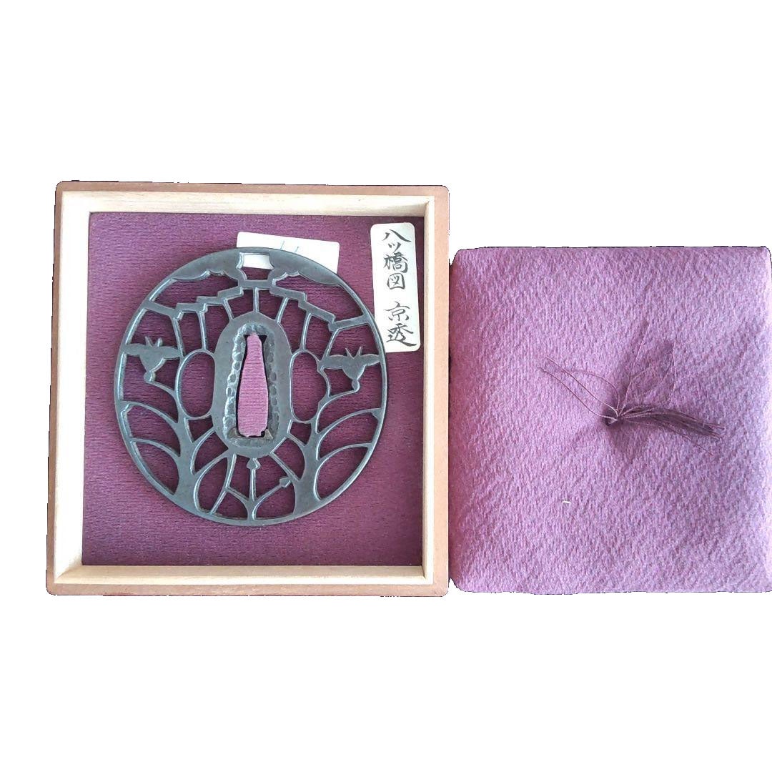 Tsuba with Yatsuhashi Design, Kyosukashi: Tsuba Yatsuhashi-zu Kyosukashi This is a tsuba (sword guard) featuring the Yatsuhashi (Eight Bridges) motif, accompanied by a paulownia wood box. It has a diameter of approximately 8.2 cm and a width