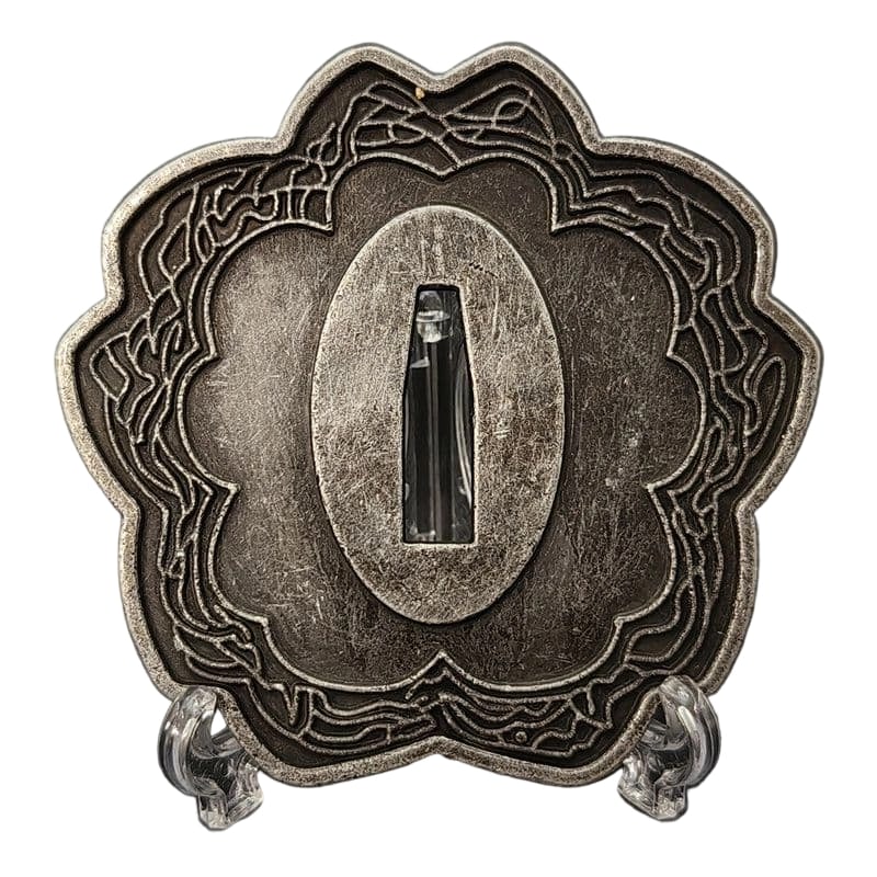 Tsuba with Cherry Blossom Design, Alloy, Modern Piece: Tsuba with Cherry Blossom Design, Alloy, Modern Piece Material: Alloy, Weight: Approximately 79 grams, Thickness: Approximately 5 millimeters. The item is only the tsuba; the sword stand is for photog