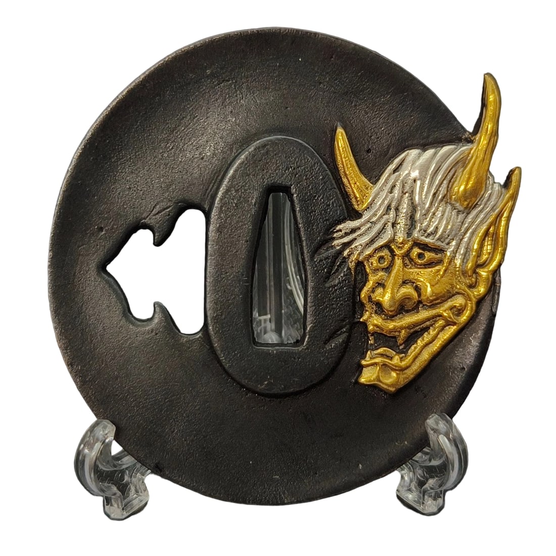 Tsuba with Design of Demons, Bronze Base with Gold and Silver Plating, Openwork Carving: Tsuba with Design of Demons Material: Made of copper, approximately 5mm in thickness, and weighing about 120 grams. The item is only the tsuba; the sword stand is for photography purposes. The item is
