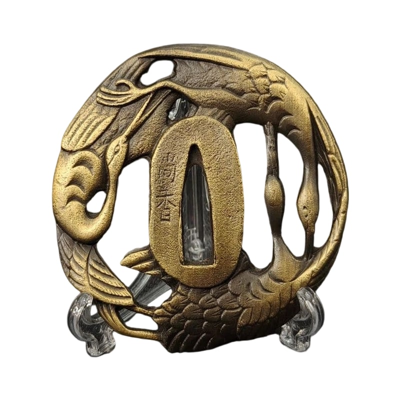 Tsuba with Crane Design, Alloy, Modern Piece. Tsuba, Sword Guard, Japanese Sword Fittings.: Tsuba with Crane Motif, Alloy, Modern Piece Material: Alloy. Weight: Approximately 106 grams. Thickness: Approximately 6 millimeters. The item is solely the tsuba; the sword stand is for photography p