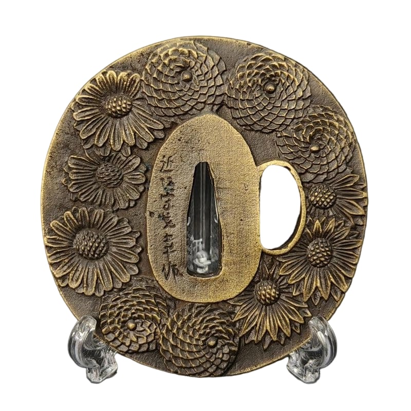 Tsuba with Chrysanthemum Design, Alloy, Modern Piece: Tsuba with Chrysanthemum Design, Alloy, Modern Piece Material: Alloy, Weight: Approximately 135 grams, Thickness: Approximately 5 millimeters. The item is solely the tsuba; the sword stand is for phot