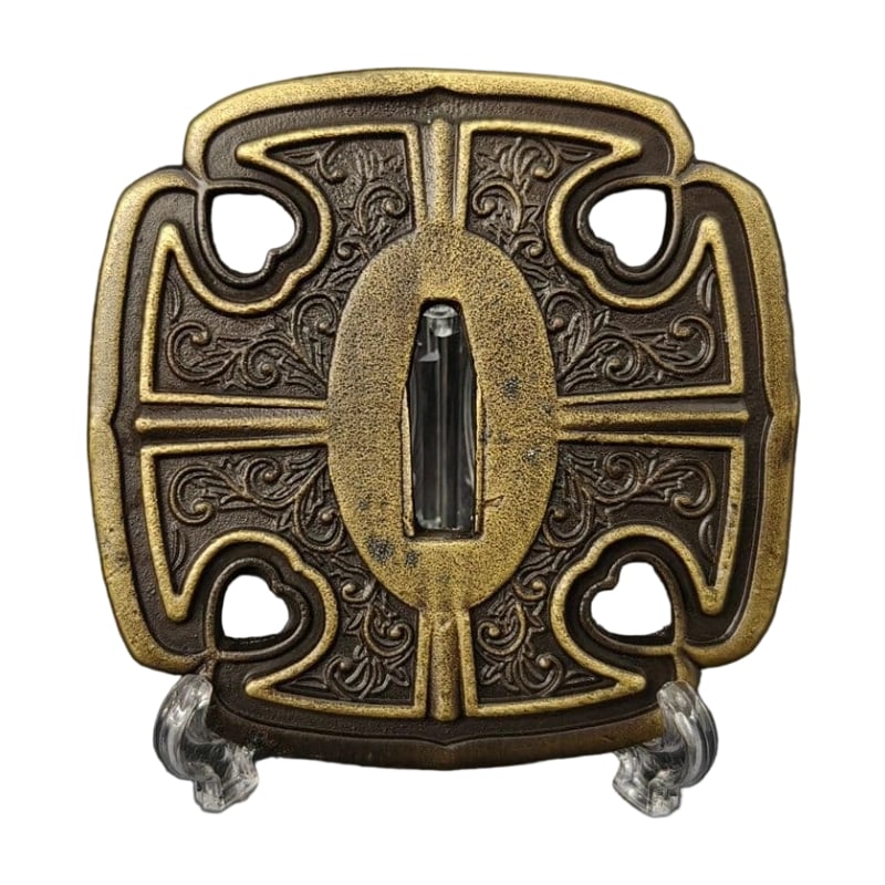 Tsuba with Inome Karakusa Design, Alloy, Modern Piece: Tsuba with Inome Karakusa Design, Alloy, Modern Piece Material: Alloy, Weight: Approximately 153 grams, Thickness: Approximately 6 millimeters. The item is solely the tsuba; the sword stand is used fo