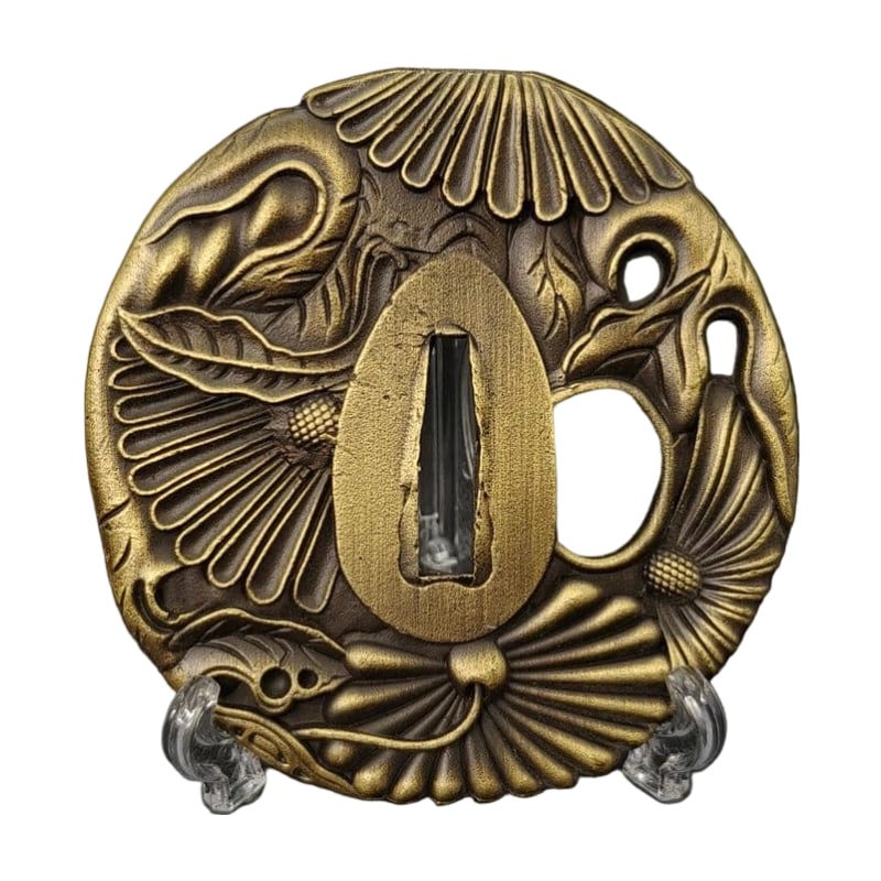 Tsuba with Chrysanthemum Design, Alloy, Modern Piece: Tsuba with Chrysanthemum Design, Alloy, Modern Piece Material: Alloy, Weight: Approximately 113 grams, Thickness: Approximately 4 millimeters. The item is solely the tsuba; the sword stand is used for