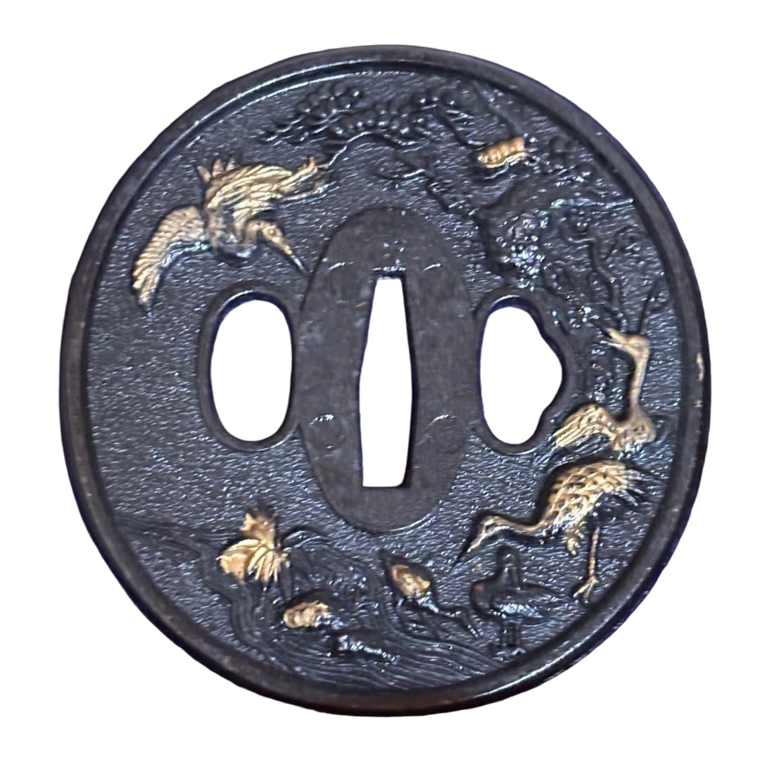 Tsuba with Crane Design, Sword Fittings, Japanese Sword: Tsuba with Crane Motif, Sword Fittings, Japanese Sword This is a round tsuba, intricately engraved with a crane and pine motif using gold inlay technique on an iron base. There is considerable rust pr