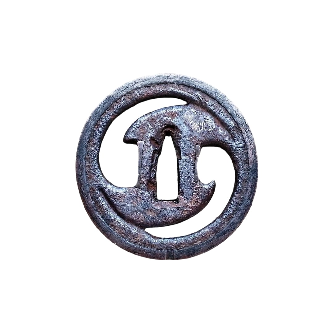 Ancient E (Sword) Paulownia: Antique Tsuba with Paulownia Design An ancient iron tsuba with an openwork design in the shape of a bar. The openwork features a paulownia leaf pattern, with edges bordered in copper or red copper. Di