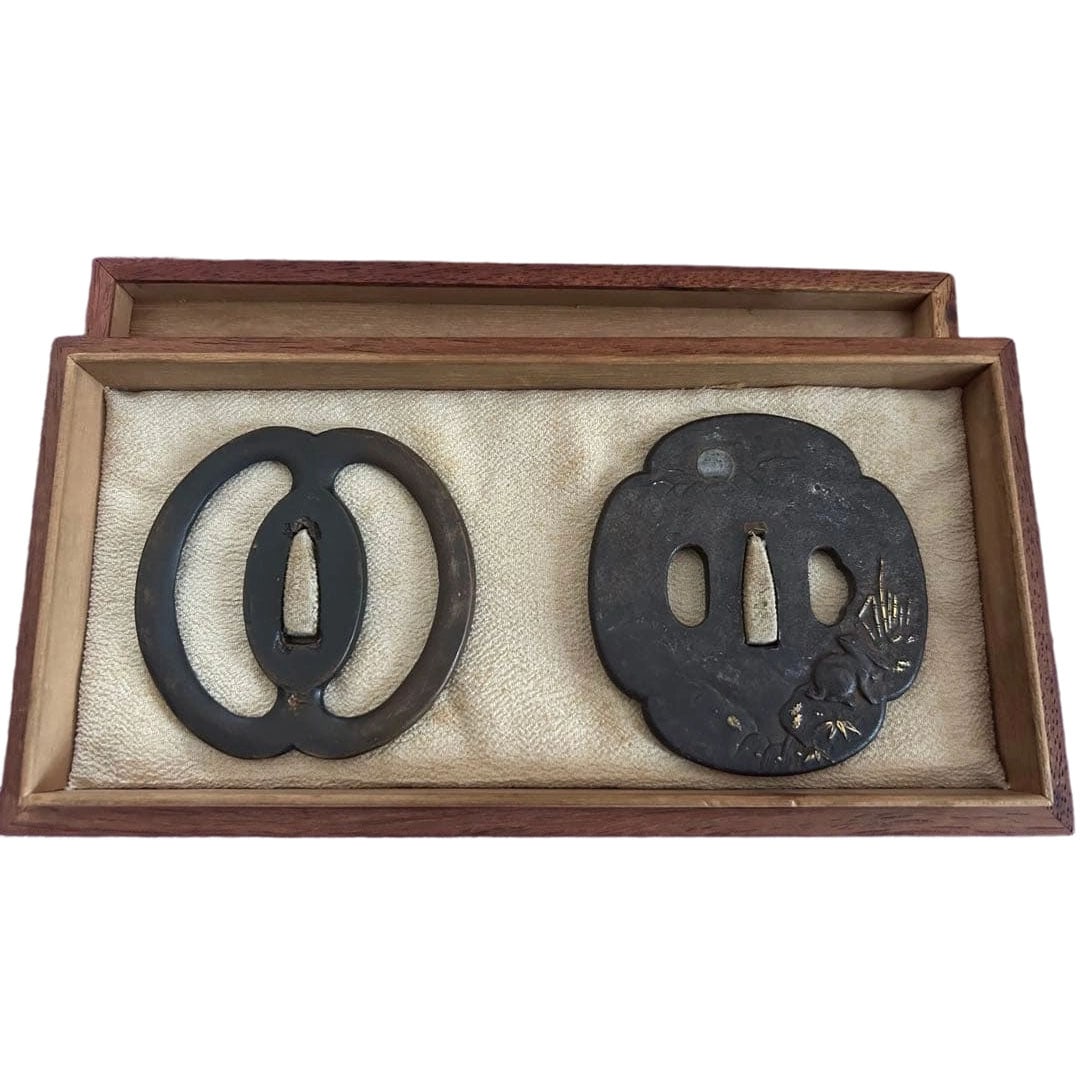 Two-piece set of swords: Musashi's Preference - Sea Cucumber Openwork Design, Elegant - Moonlit: A set of two Japanese sword guards (tsuba), accompanied by a paulownia wood box. 1. Miyamoto Musashi's Preferred Sea Cucumber Openwork Tsuba: The design features traditional sea cucumber openwork,