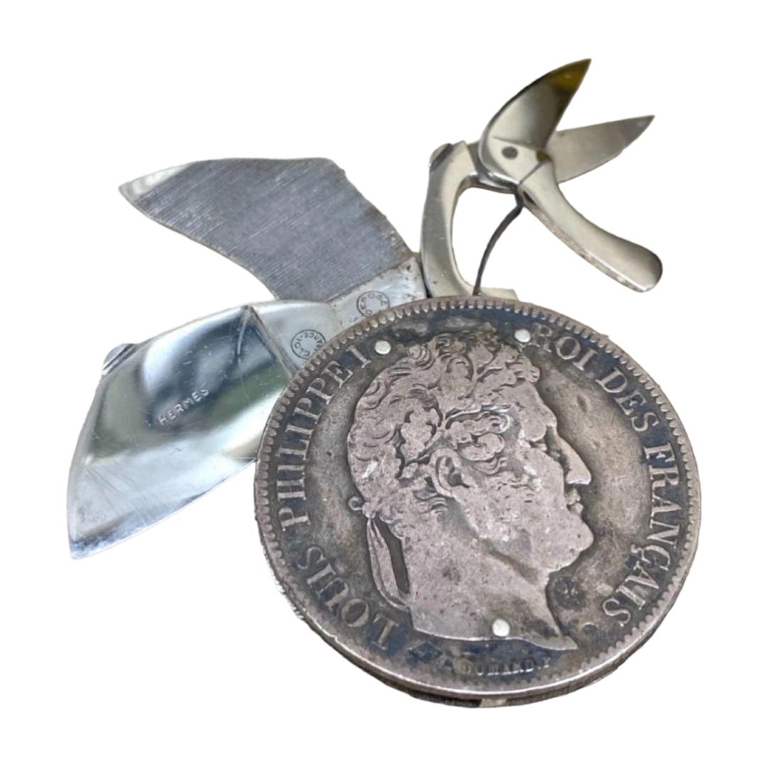 Extremely Rare HERMES Vintage Silver Antique Coin Multi-Functional Tool: Split from an 1841 antique silver coin, Hermes has crafted it into a multifunctional tool, making it extremely precious. Due to its nature as an antique silver coin, it has developed an elegant antiqu