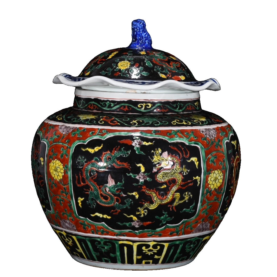 Ming Jiajing Blue and White Wucai Dragon Pattern Covered Jar: This covered jar is a blue and white wucai piece from the Ming Jiajing period, featuring vivid dragon patterns and vibrant colors, characteristic of its era. The jar has a full shape and exquisite cra