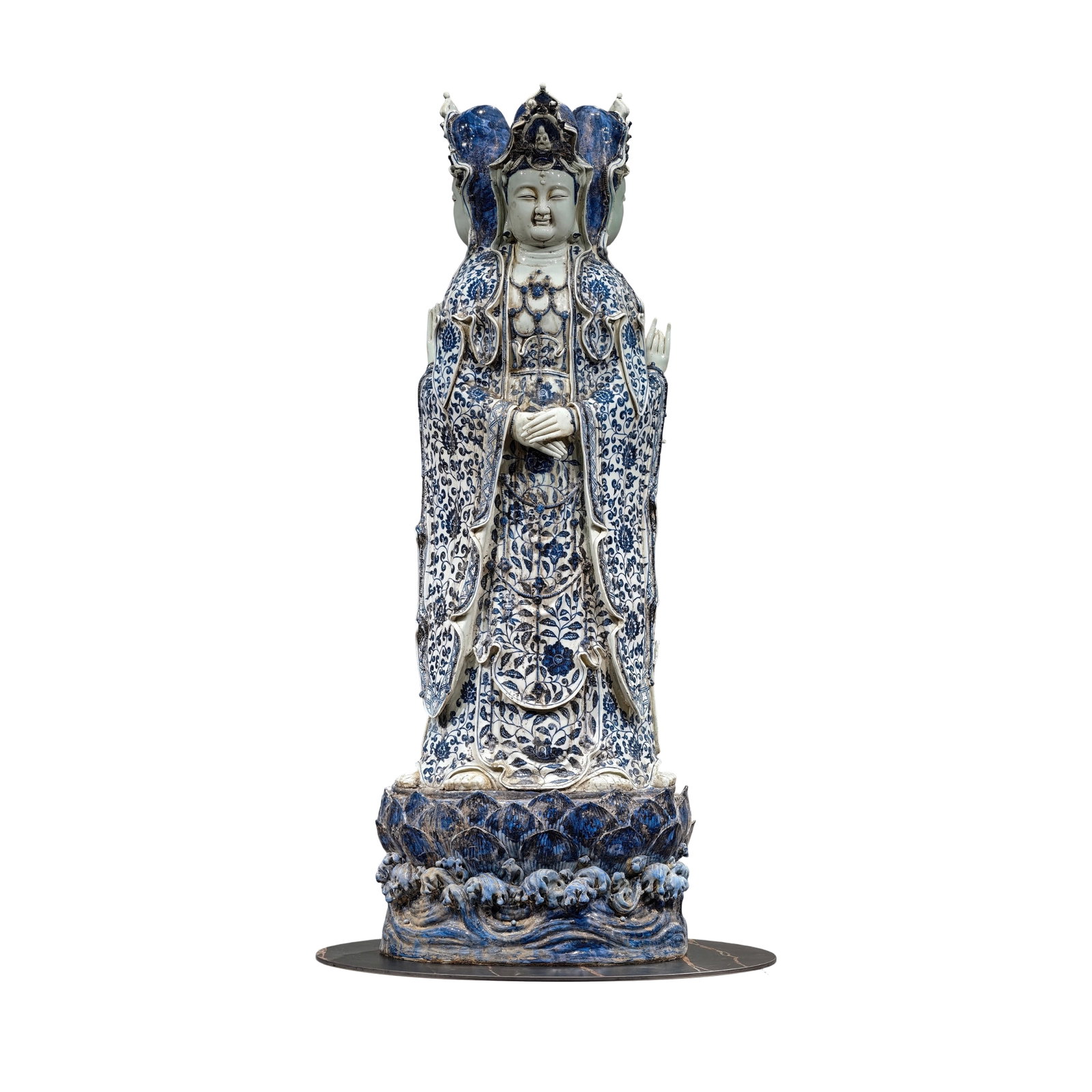 Ming Dynasty Blue and White Lotus Pattern Three-faced Guanyin Statue: This Guanyin statue is exquisitely crafted, with delicate facial features, drooping eyes, a straight nose, and a compassionate smile. The face is plump and solemn. The proportions are accurate, and