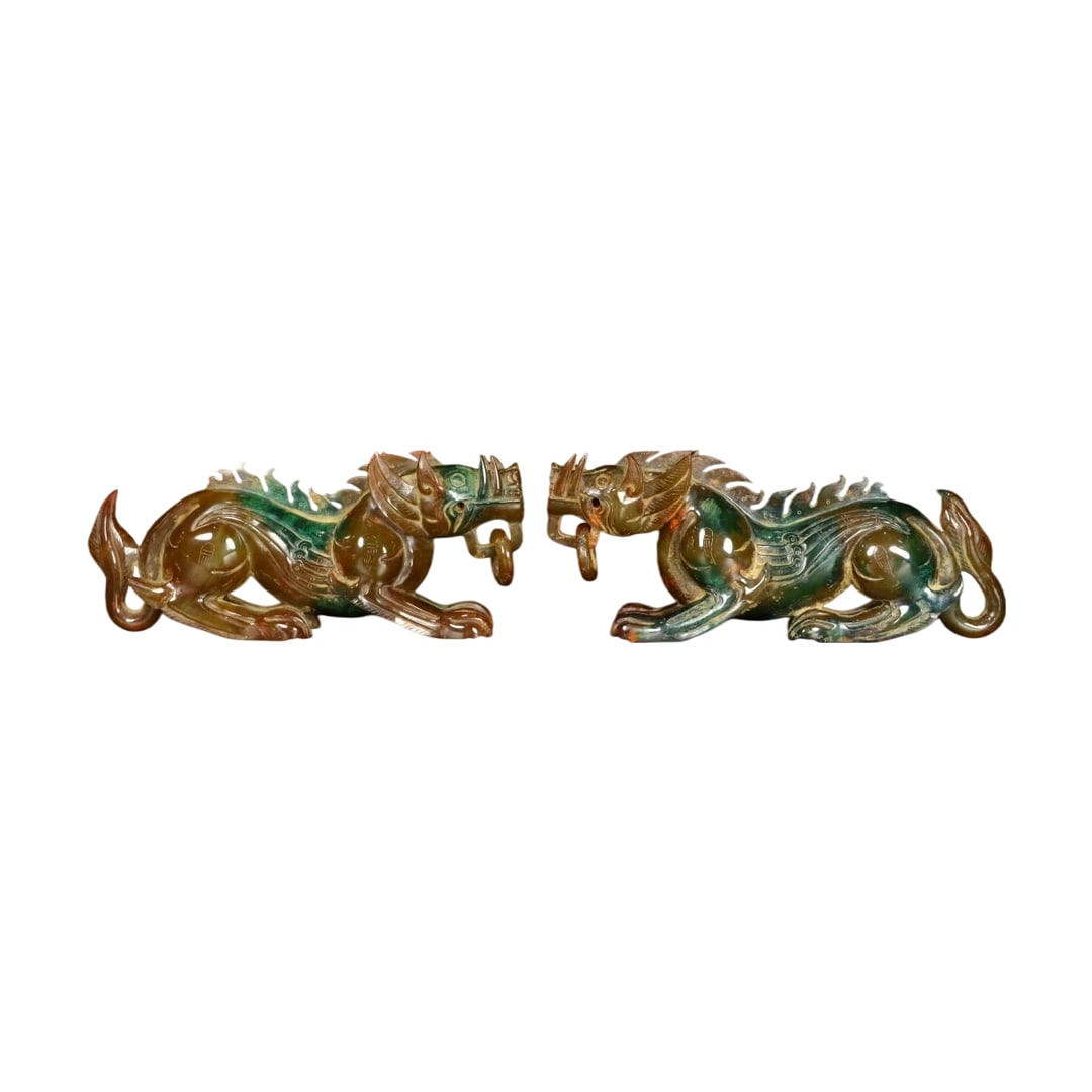 Pair of Hetian Jade Pigs: This pair of Hetian jade pigs features exquisite craftsmanship and a warm jade texture, showcasing the artisan's superb skills. (Length 21cm, Width 5cm, Height 8.5cm, Single weight 791g)