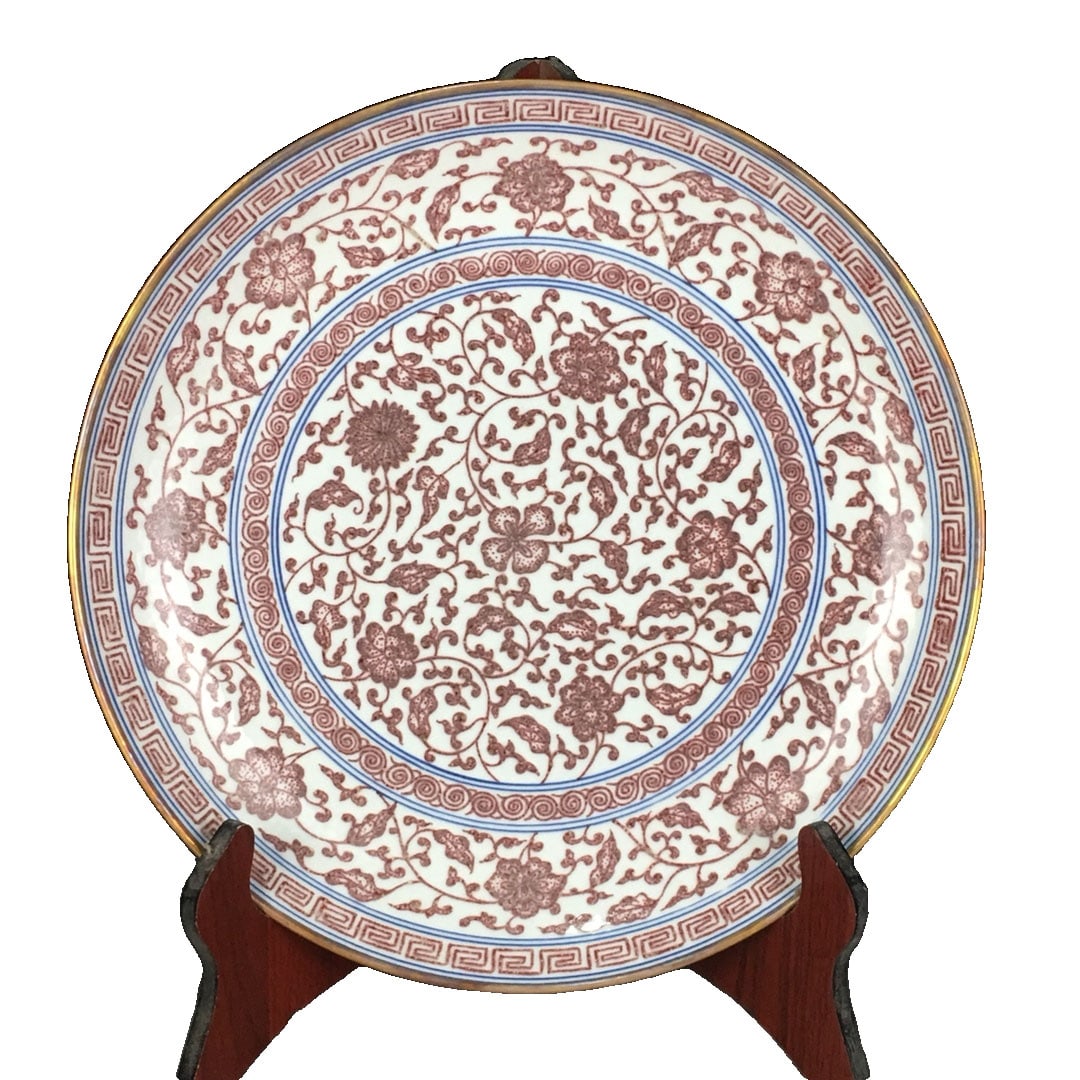Qing Dynasty Qianlong Gilt Red Glaze Lotus Scroll Plate: This plate is a fine piece from the Qianlong period of the Qing Dynasty, combining red glaze with gilt craftsmanship for a splendid visual effect. The lotus scroll motif is intricately and smoothly