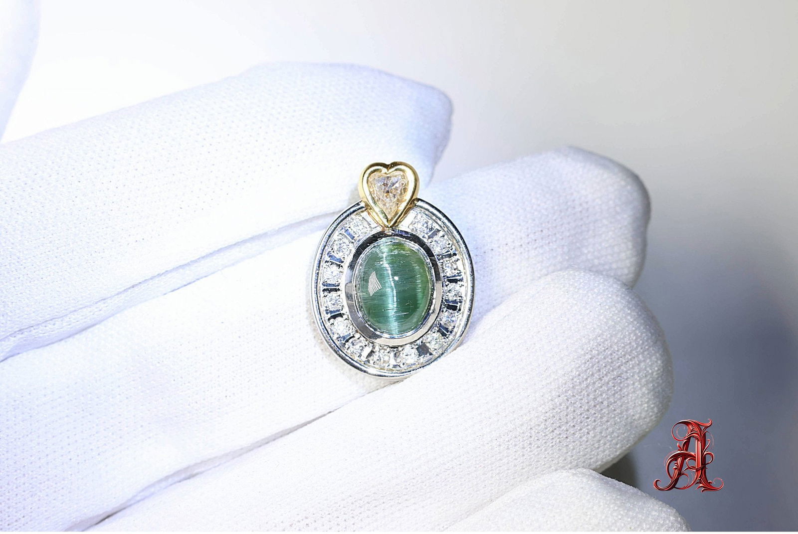 Platinum & 18k Gold, Tourmaline Cats Eye & Diamond Pendant 2.569ctw, 6.5 Grams Gemstone Jewelry Diam: size: 21mm x 15.5mm, weight: 6.5 grams, material: platinum & 18k yellow gold, gemstone:cats eye tourmaline: 2.14ct, diamonds: 0.21ctw G-H color SI clarity | heart shaped 0.219ctw yellow I clarity