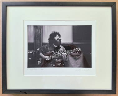 Jerry Garcia Photo signed and dated '69 by Jim Marshall: Jerry Garcia photo signed and dated 1969 by Grateful Dead photographer Jim Marshall, with the photographer's address stamp and inventory number on reverse. 'Jamming', show Jerry Garcia in mid-solo