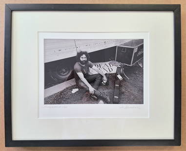 Jerry Garcia Photo signed and dated '69 by Jim Marshall: Jerry Garcia photo signed and dated 1969 by Grateful Dead photographer Jim Marshall, with the Photographers address stamp on reverse. 'Dead End', shows Jerry Garcia sitting by a truck with his guitar