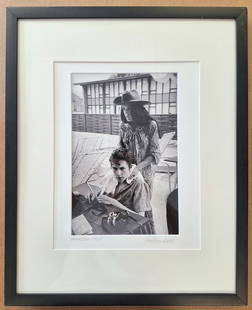 Bob Dylan Photo signed and dated '64 by Jim Marshall: Bob Dylan and Joan Baez photo signed and dated 1964 by famed photographer Jim Marshall, with the photographer's address stamp and inventory number on reverse. 'Bob & Joan', shows Bob Dylan seated with