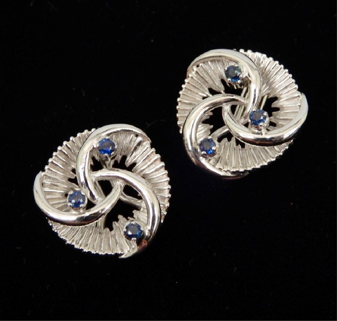 18k white gold and sapphire earrings: White gold clip earrings, each set with three small sapphires, 18k white gold circular design with fluted background, 3/4" in diameter, Omega clip backs, stamped K1 18 (18k), 12.8 grams/8.2 dwt