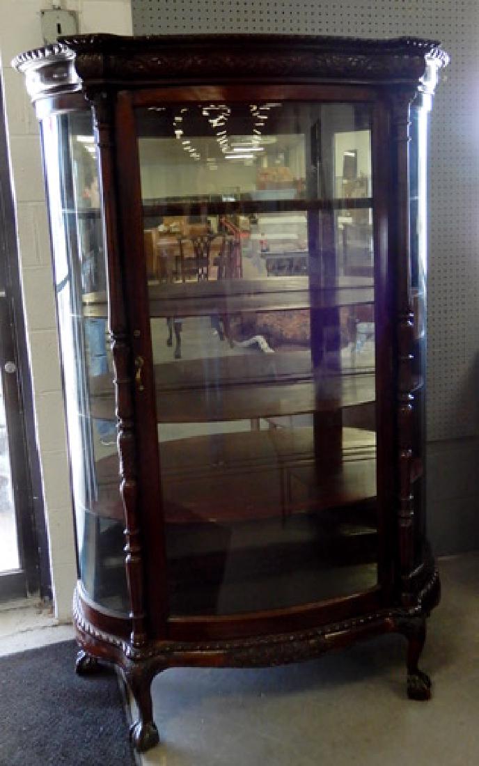Oak bent glass china cabinet: Oak bent glass china cabinet, curved front and sides, carved side columns, ball and claw feet, 70 1/2" high x 43" x 16"