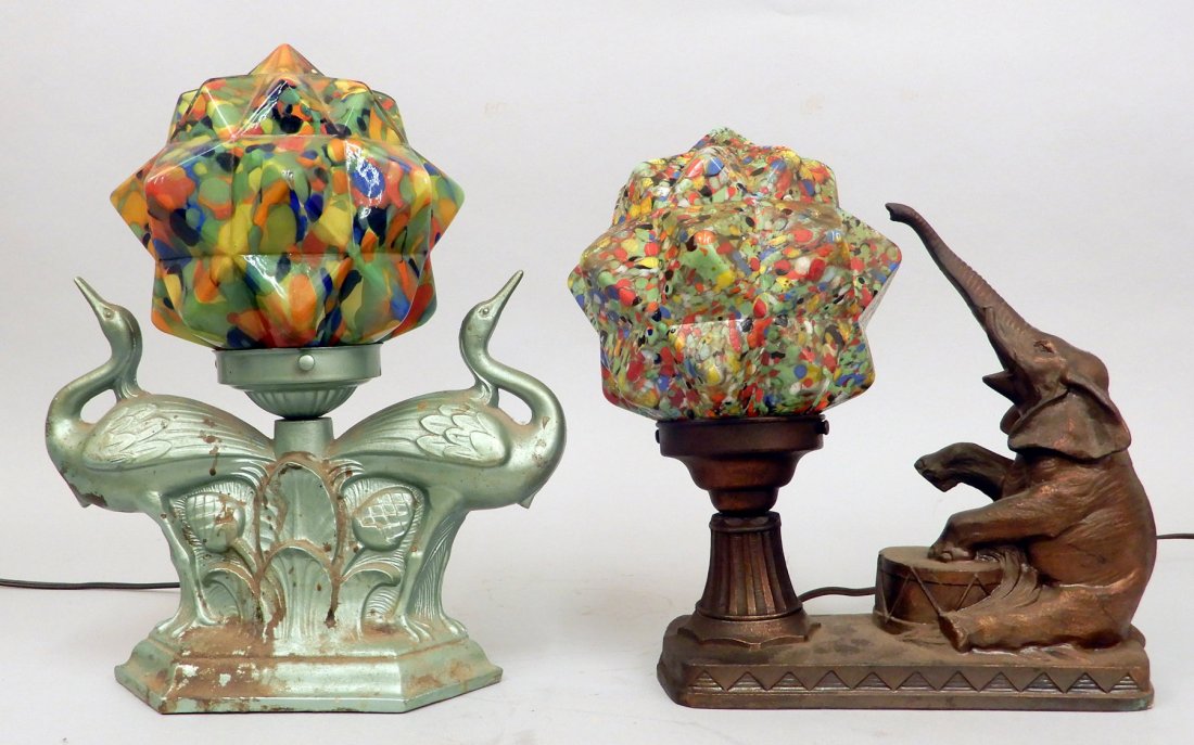 Two Art Deco table lamps, glass starburst globes: Two Art Deco table lamps with Czech end of day glass starburst globes. Including one with painted spelter metallic green double crane base, marked No. 89, some loss to paint, and a hole in glass shade