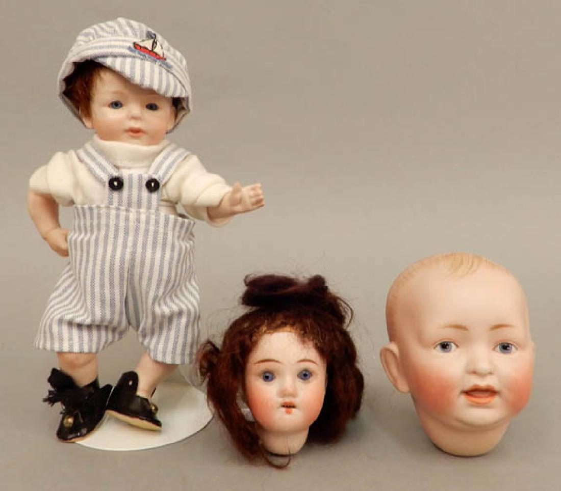 Two bisque doll heads and a Kestner bisque doll: Two bisque doll heads and a Kestner bisque doll, includes JD Kestner bisque solid dome doll head, painted features, open mouth, incised "JDK, 7, Made in Germany", 3 1/2", Recknagel bisque socket head,