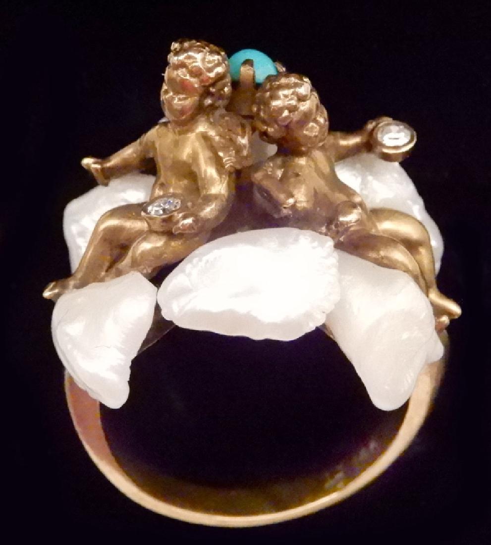 Gold, pearl and diamond figural cherub ring: Gold, pearl and diamond figural cherub ring, 14k gold ring with two full figured cherubs sitting back to back on a bed of six large fresh water pearls, each cherub is holding one round diamond measuri