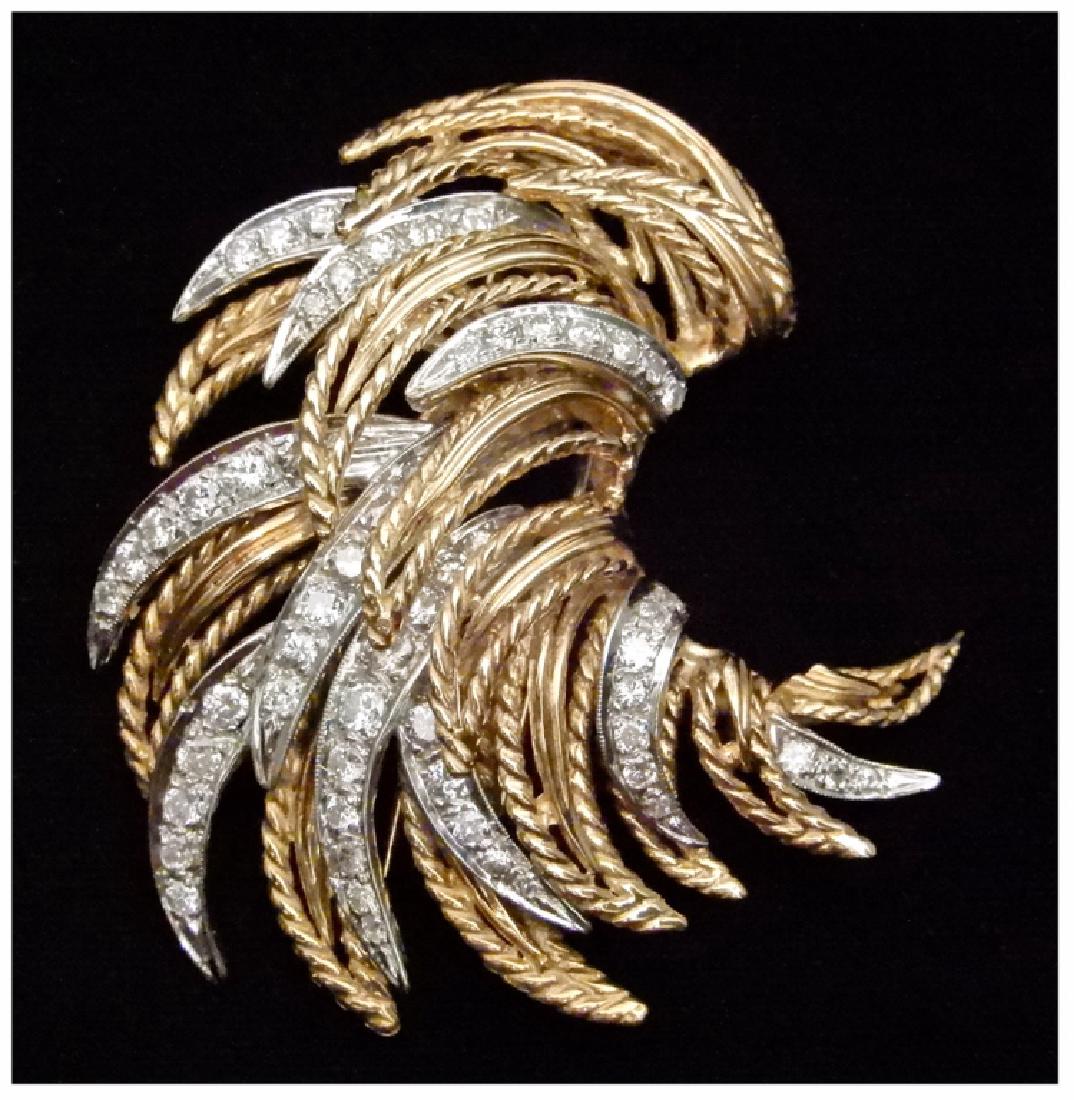 Two tone gold and diamond clip: Two tone gold and diamond clip, 18k white and yellow gold clip, sprays of diamonds backed in white gold and elongated leaf shapes with twisted rope edges in yellow gold, fifty six round diamonds measu