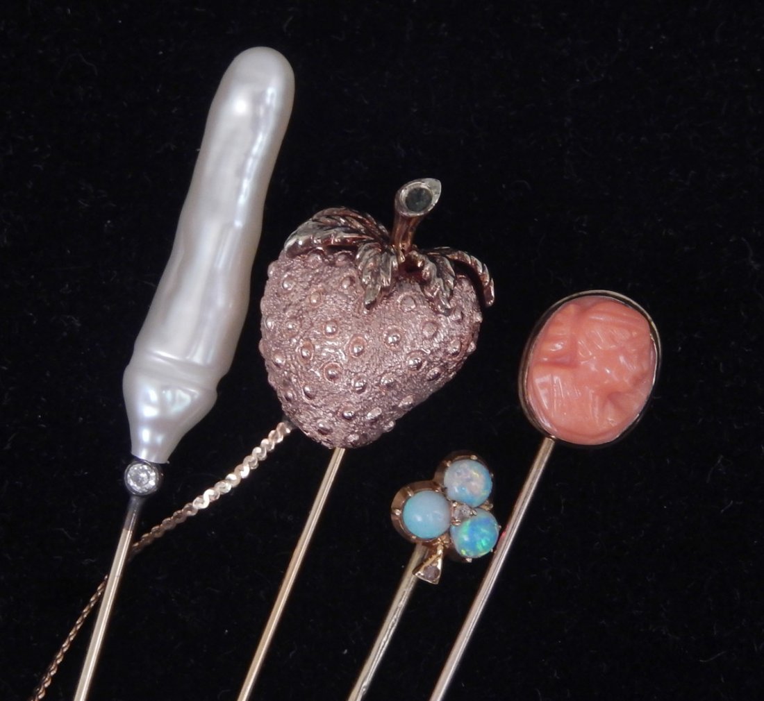 Gold stick pin grouping: Gold stick pin grouping, four gold stick pins including one apple motif in rose and yellow 14k gold with small emerald in stem, 2 3/4" long, gold plated clutch is on a safety chain, stamped 14k, one V