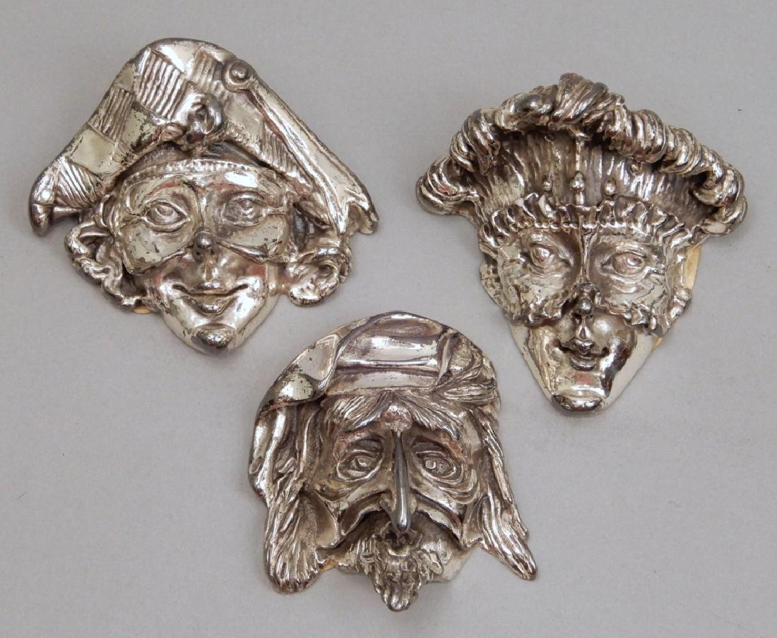 Three sterling silver masks: Three sterling silver masks, depicting Pantalone, Colombina, and Arlecchino, each with label on back "Argenteria Lanzellotti, LM, Via Martiri 6 Ottobre, 44. Lanciano.ch", each with hallmarks "R, 3/5g,