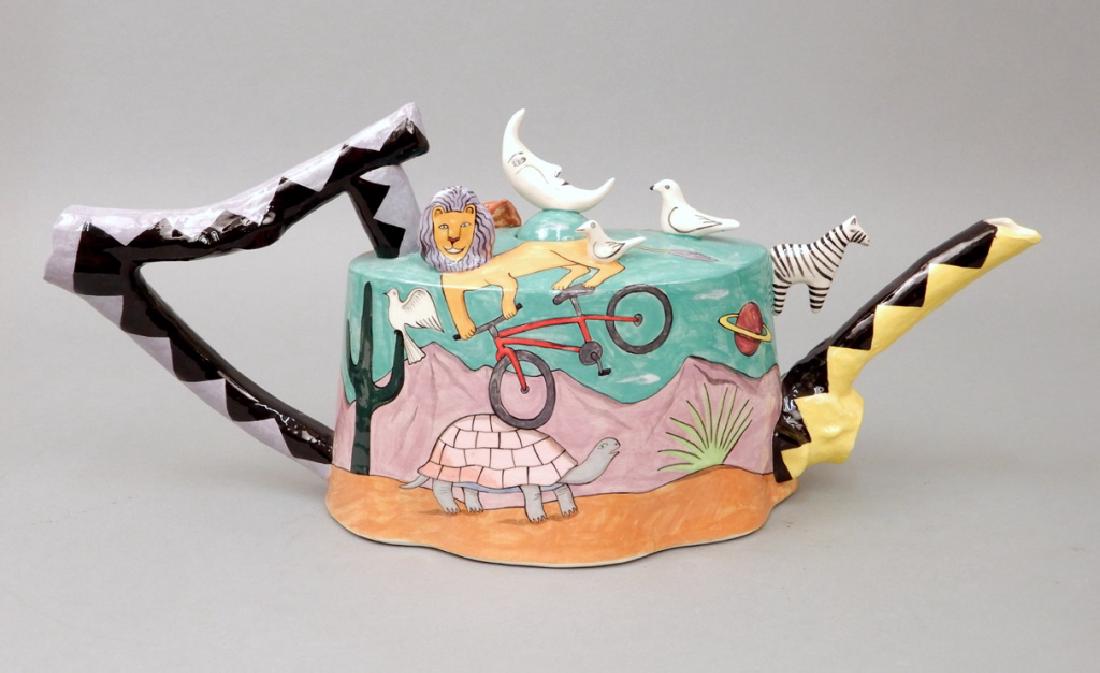 Garson & Pakele painted ceramic teapot: Garson & Pakele painted ceramic teapot, depicting lion riding bike on turtle, applied birds and zebra, fish, fox, horse, baby in cradle, rabbit, and moons, signed on bottom Garson-Pakele, measures 8" 