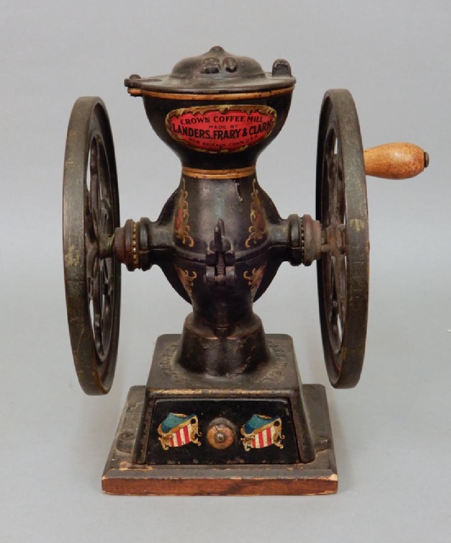 Landers, Frary & Clark cast iron Crown Coffee Mill: Landers, Frary & Clark cast iron Crown Coffee Mill No. 20, painted, mounted on wooden base, single drawer, measures 12 3/8" x 10 3/4" x 9 1/4"
