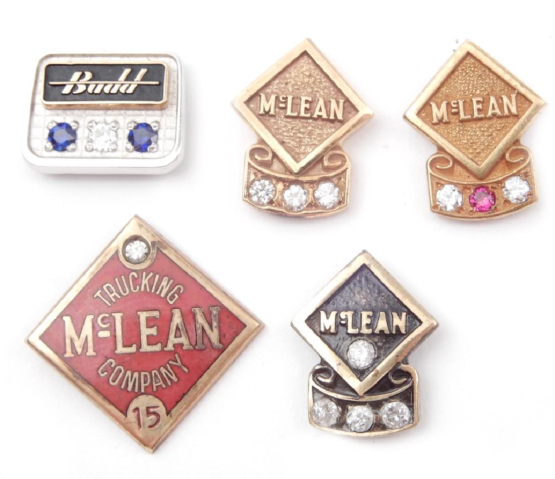 Five 10k gold advertising employee pins: Five 10k gold advertising employee pins, one 10k gold McLean Trucking Company with two small diamonds and a ruby, 1/2" long, stamped 10k, one enameled 10k gold McLean Trucking Company with small diamo