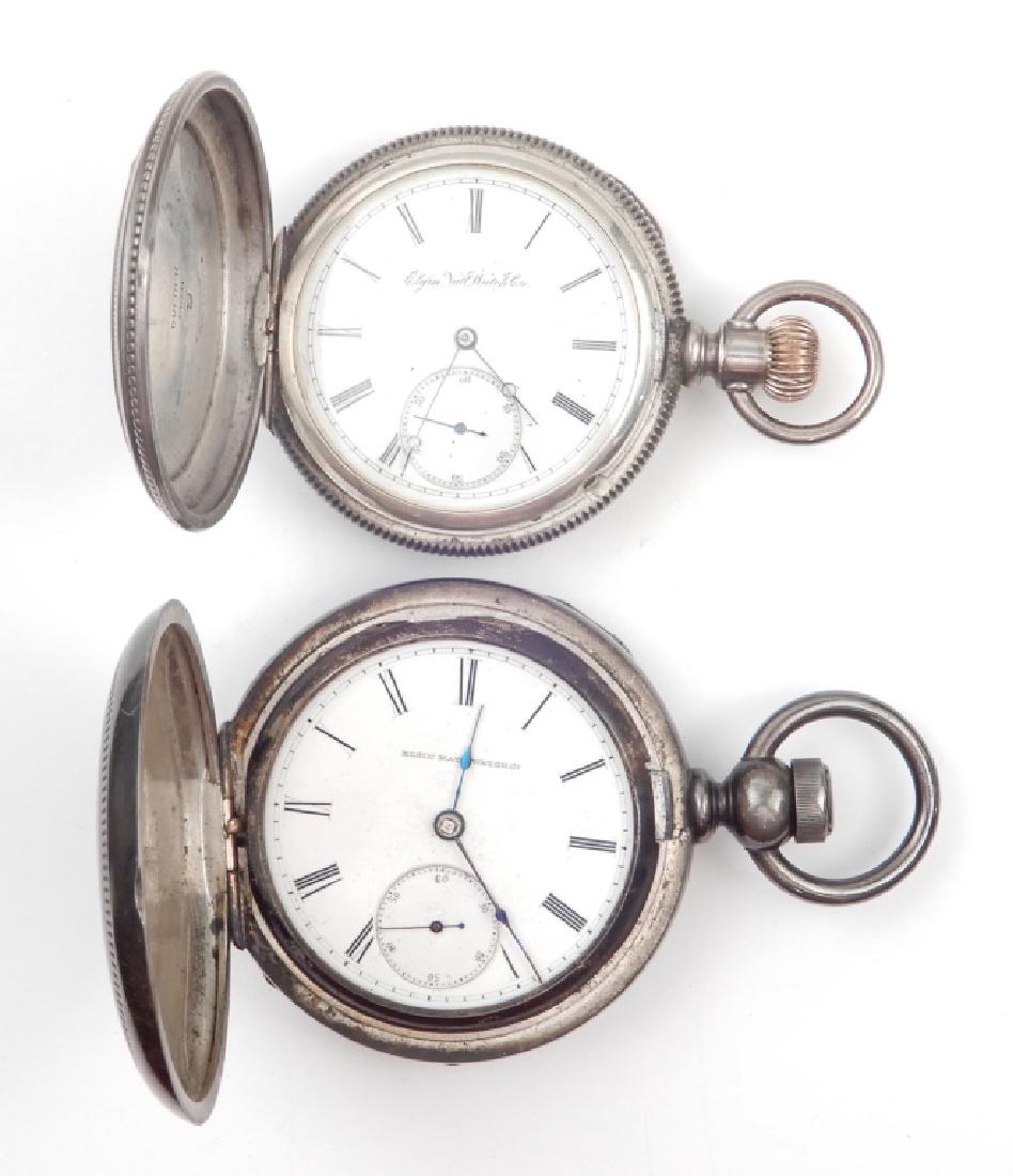 Two Elgin coin silver pocket watches: Two Elgin coin silver pocket watches, one key wind with engraved hunting case, 2 1/4" diameter, inside of case stamped Keystone Coin 120261, face marked "Elgin National Watch Co."; second watch with e