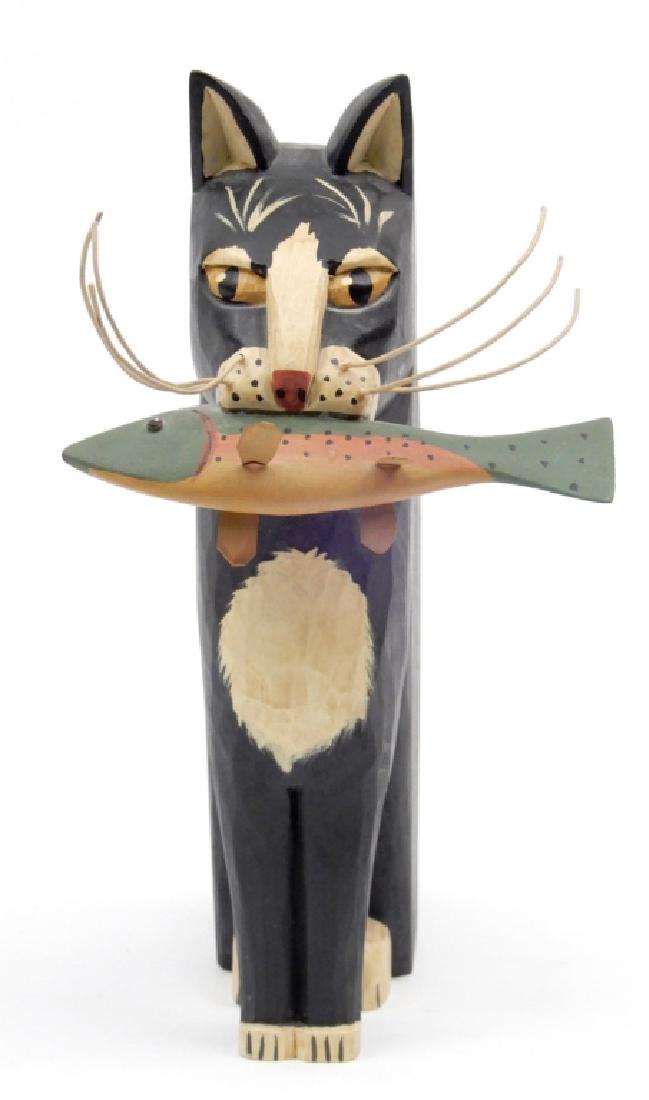 Pennsylvania contemporary folk art G&G Hosfeld: Pennsylvania contemporary folk art G&G Hosfeld sculpture, carved and painted sculpture of a seated cat holding a fish in its mouth, artist signed and dated on bottom "G&G Hosfeld 1983, Souderton, PA",