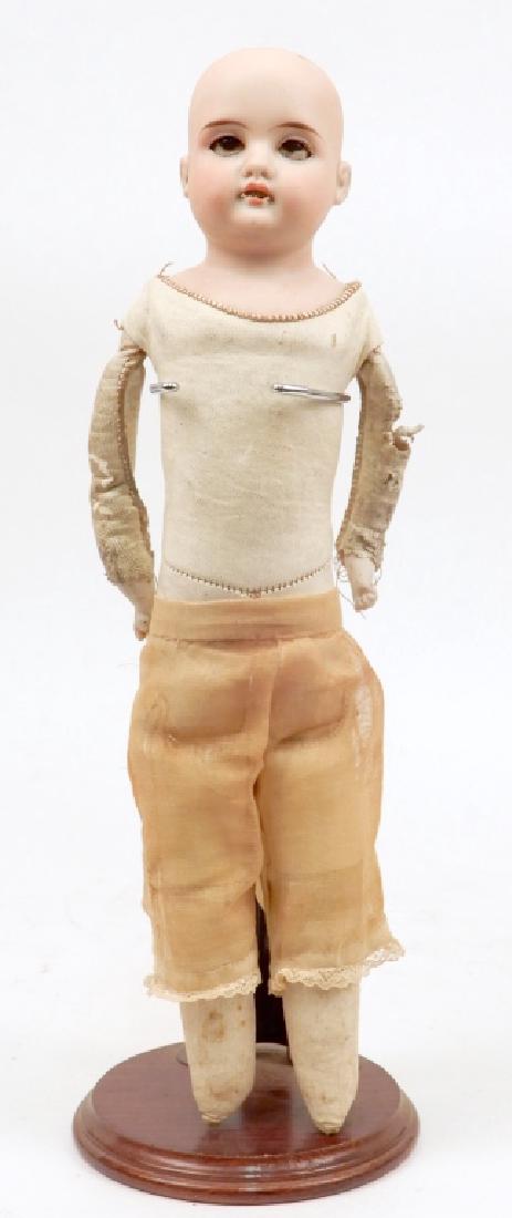 German bisque shoulder head doll: German bisque shoulder head doll, kid leather body, bisque lower arms, cloth lower legs, brown glass sleep eyes, painted lashes and eyebrows, open mouth with upper teeth, incised on neck "Made in Germ