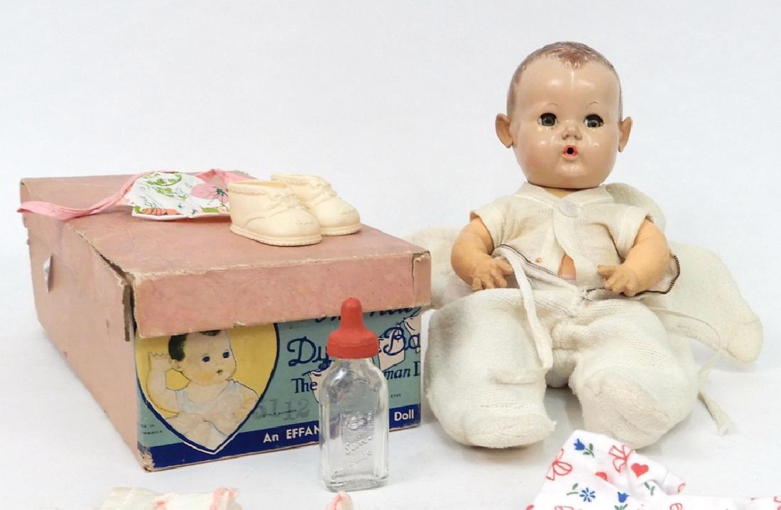 Effanbee DyDee baby doll in box with clothes: Effanbee DyDee baby doll in box with clothes, doll measures 11" tall, with additional clothes and glass baby bottle, box measures 11 5/8" x 5 5/8" x 4"