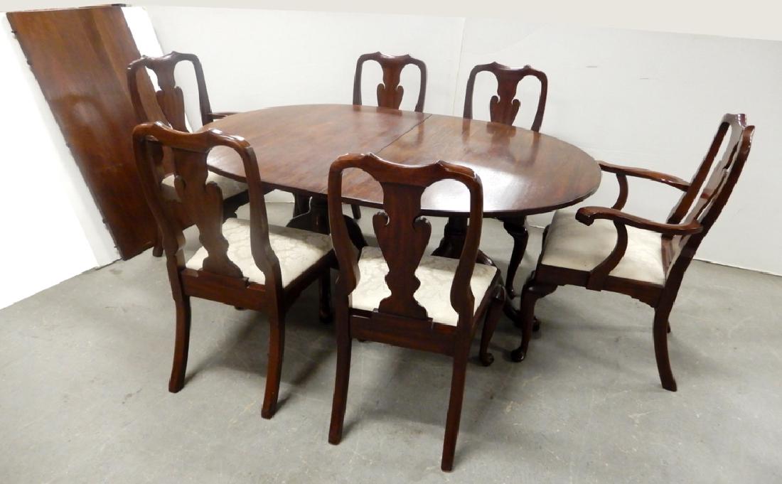 Kittinger two piece dining table with Henkel Harris: Kittinger mahogany two piece dining table 66" with one 24" leaf, Kittinger Williamsburg brand and paper label, and six Henkel Harris mahogany dining chairs 39" high