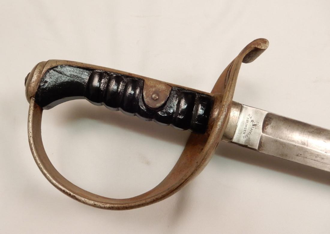 1896 Austria Hungary Cavalry Sabre: 1869 Austria Hungary Cavalry Sabre in scabbard, wood grip, marked on ricasso P.D. Luneschloss, GF on other side of ricasso, marked on ring on scabbard, blade length 35 1/4", overall length 43 1/2"