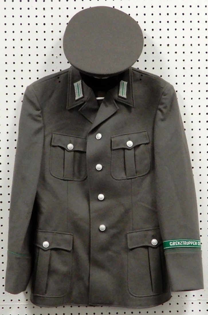East German Grenztruppen jacket and visor cap: East German Grenztruppen jacket and visor cap, jacket tag g48, stamped inside NVA g48, 1802 1H, with cuff title Grenztruppen Der Dor, and visor cap, stamped Made in East Germany, marked NVA 56, 1856 N