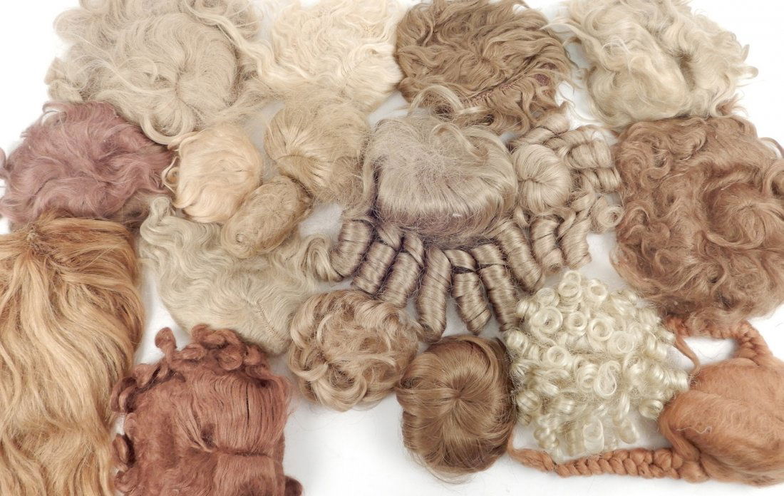 Large assortment of doll wigs, various sizes, (1 of 2)
