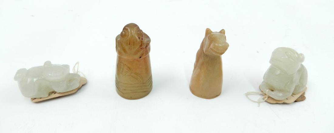 Two Chinese carved jade thimbles a pair of miniature: Two Chinese carved jade thimbles a pair of miniature jade guardian lions, thimbles are horse head and frog, 1 1/2" each, lions 1 1/2", with wax seals on original tags