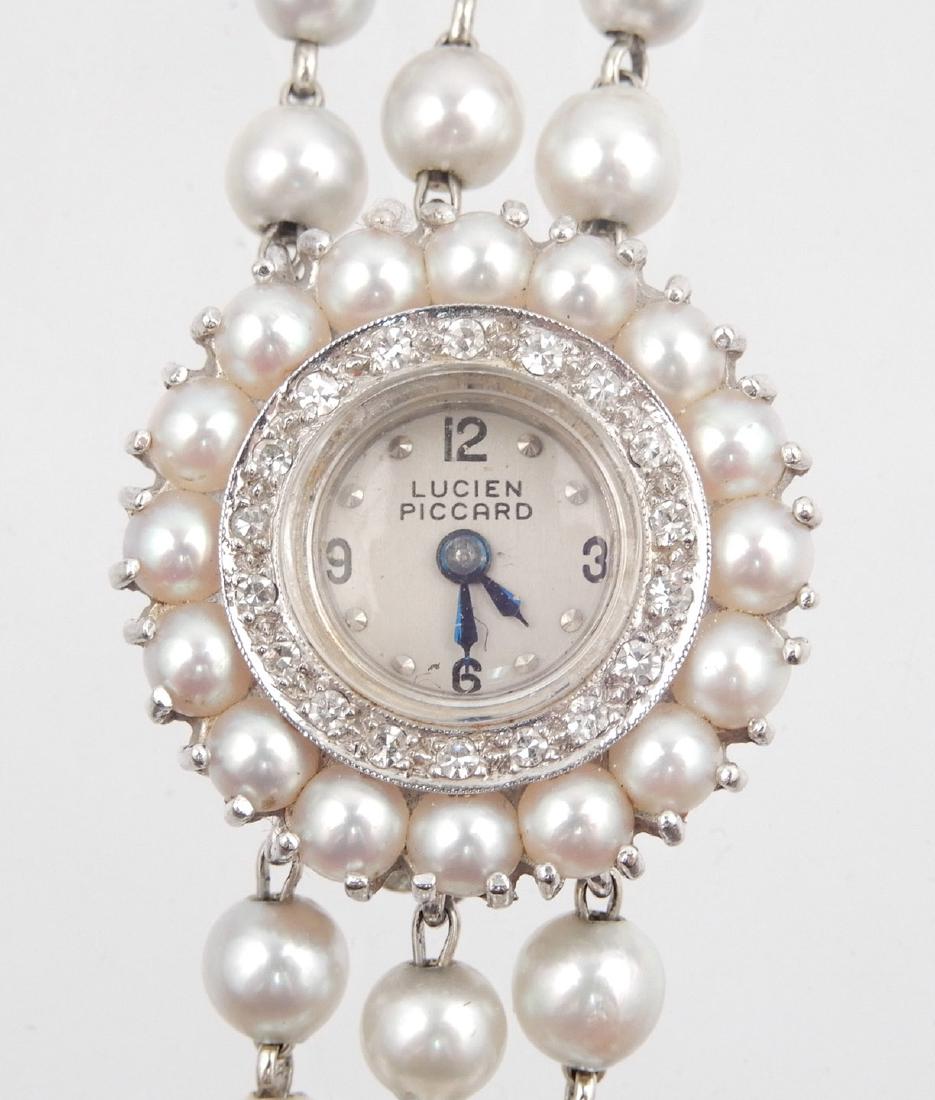 Lady's Lucien Piccard 14k white gold diamond and pearl: Lady's Lucien Piccard 14k white gold diamond and pearl wristwatch, round case measures 7/8" in diameter, diamond bezel with additional ring of pearls, triple row pearl band, 6 1/2" long, clasp stamped