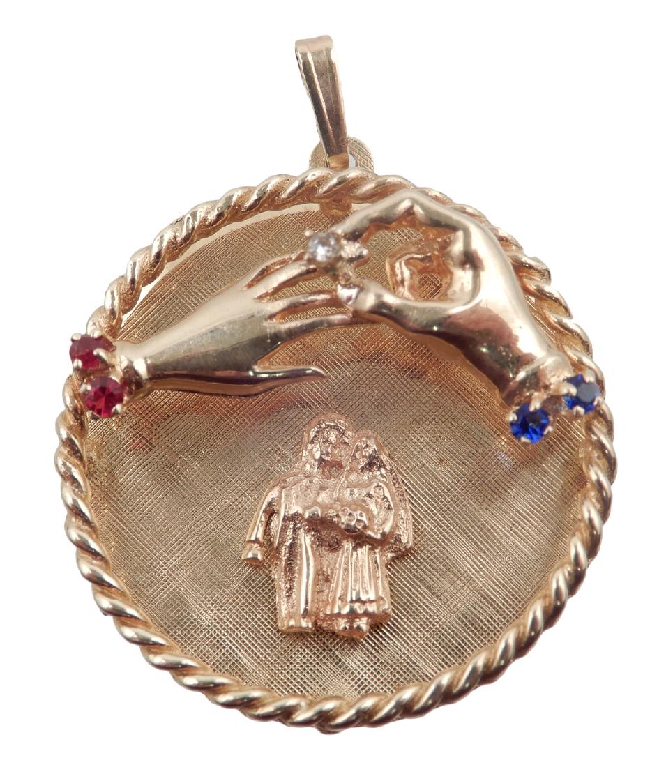14k gold wedding remembrance pendant: 14k gold wedding remembrance pendant, disc shaped pendant with raised rope edge, two hands exchanging wedding rings, bride and groom, small rubies, sapphires and diamond, 1 1/4" diameter, engraved on 