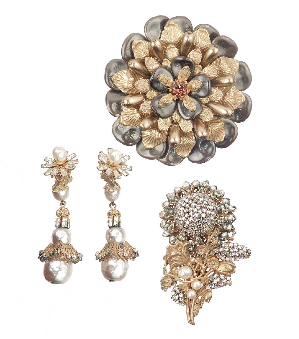 Grouping of vintage Miriam Haskell costume jewelry: Grouping of vintage Miriam Haskell costume jewelry; included are large faux gray and gold pearl flower pin in gold tone metal with amber color center stone, 3" in diameter, filigree back with Miriam H