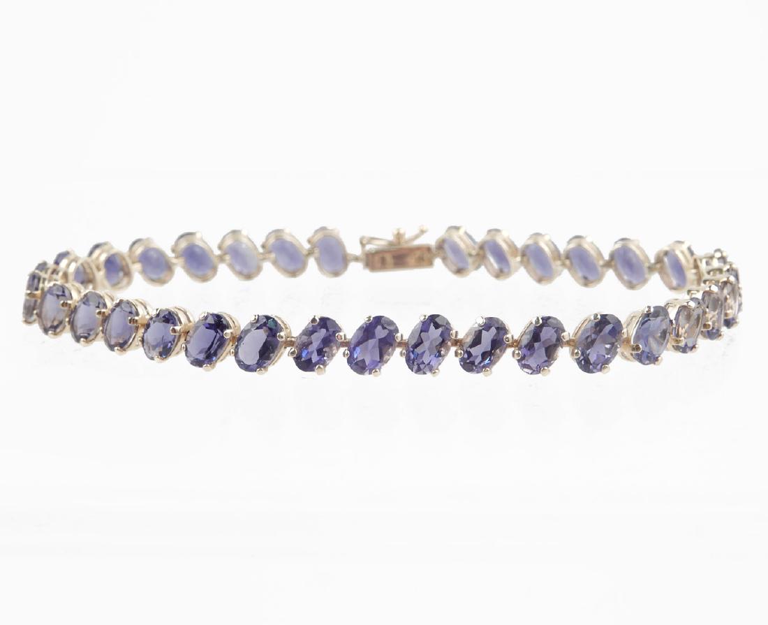 14k gold iolite bracelet: 14k gold iolite bracelet, oval faceted stones set diagonally, 7 1/4" long x 1/4" wide, stamped 14k, weight 8.1 grams/5.2 dwt